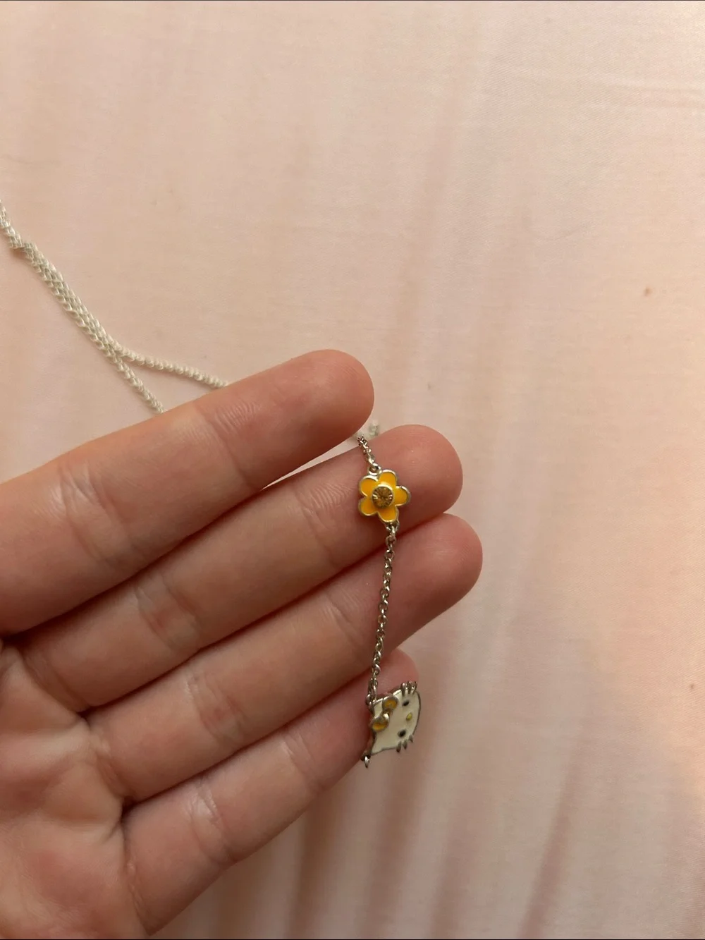 Hello Kitty Silver Necklace with White Enamel Face and Gold Flower Accent